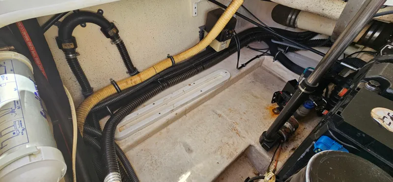 Slide: The Image of Engine compartment of a 2004 Formula 260 Bowrider with visible hoses and components. - 17