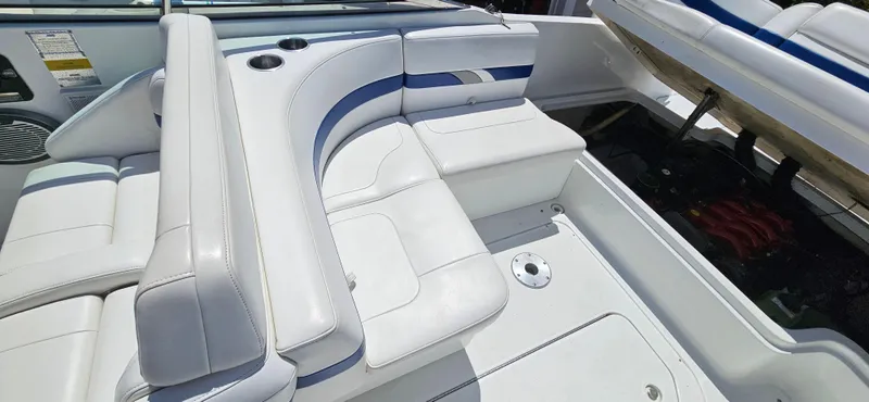 Slide: The Image of 2004 Formula 260 Bowrider interior with white and blue seating, open engine compartment. - 18
