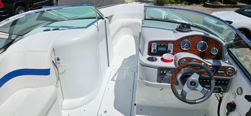 Slide: The Image of 2004 Formula 260 Bowrider boat interior with steering wheel and dashboard controls. - 2