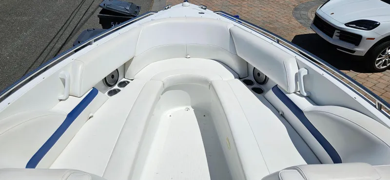 Slide: The Image of 2004 Formula 260 Bowrider boat interior with white seating and blue accents. - 3