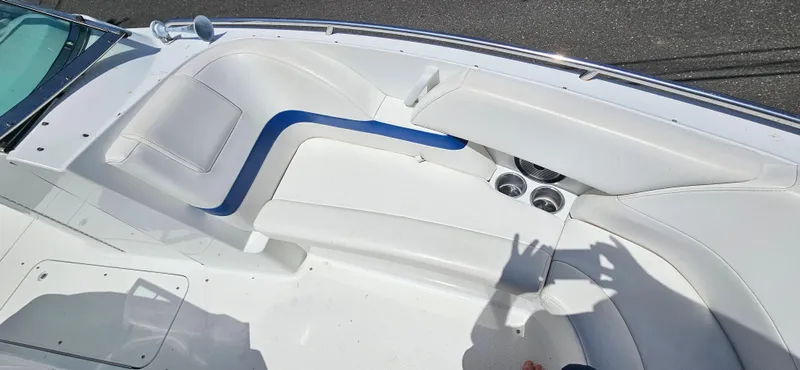 Slide: The Image of 2004 Formula 260 Bowrider boat interior with white seating and cup holders. - 8