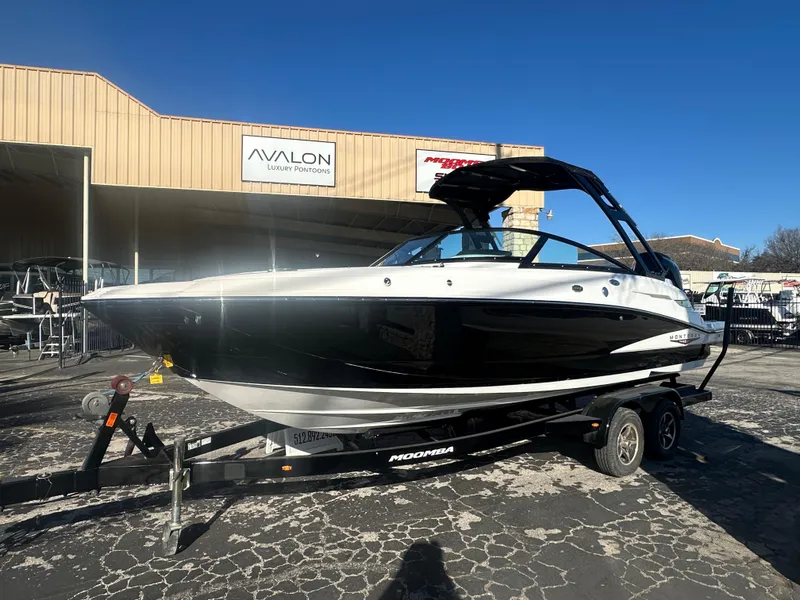 Slide: The Image of 2025 Monterey M-45 boat on trailer outside Avalon dealership. - 1