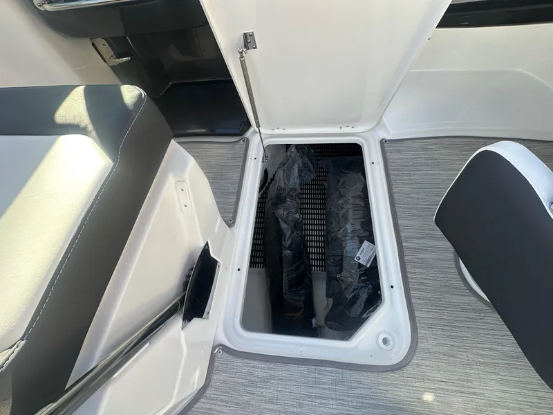 Slide: The Image of Open storage compartment in 2025 Monterey M-45 boat interior with gray flooring. - 12
