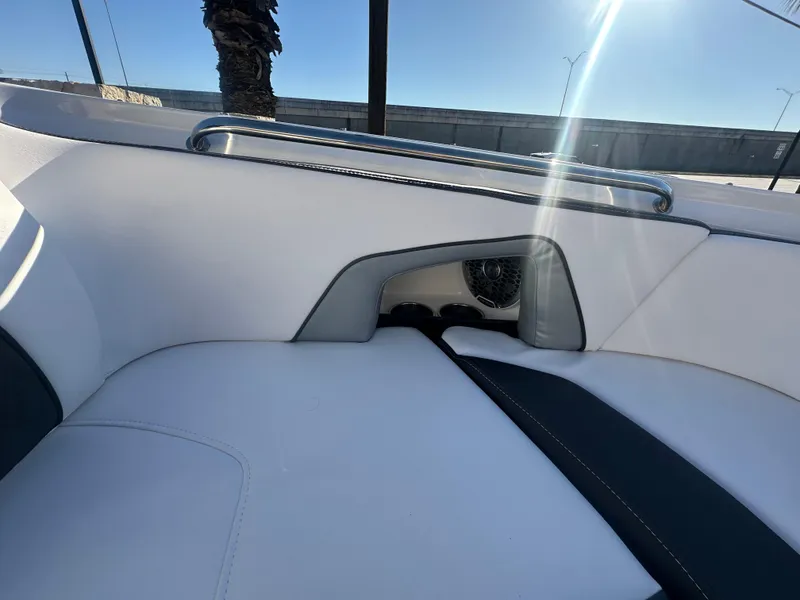 Slide: The Image of 2025 Monterey M-45 boat interior with white and black seating, chrome rail, and sunlight. - 13