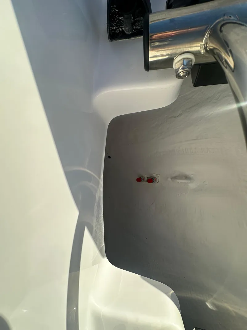 Slide: The Image of Close-up of a 2025 Monterey M-45 boat detail, featuring sleek white surfaces and metal fixtures. - 18