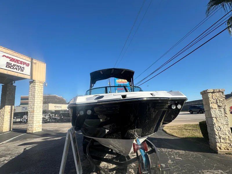 Slide: The Image of 2025 Monterey M-45 boat displayed outdoors at a dealership under a clear blue sky. - 2