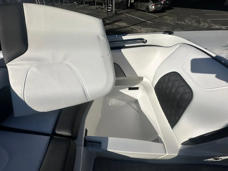 Slide: The Image of 2025 Monterey M-45 boat interior with white and black seating, open storage compartment. - 23