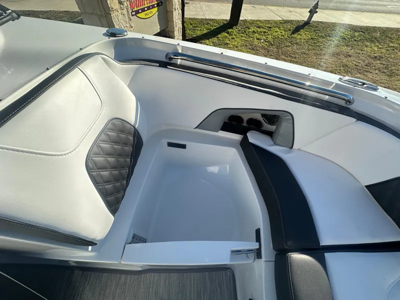 Slide: The Image of 2025 Monterey M-45 boat interior with white and black seating, cup holders, and sleek design. - 26