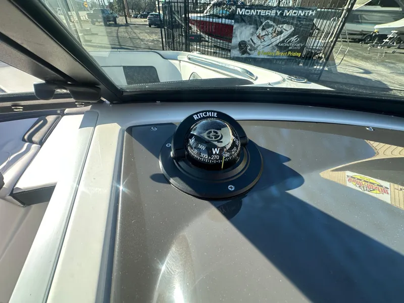Slide: The Image of Compass on 2025 Monterey M-45 boat dashboard, with outdoor marina view. - 31