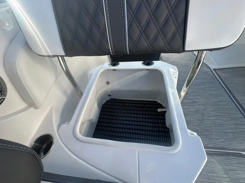 Slide: The Image of 2025 Monterey M-45 boat seat with integrated storage compartment, featuring black and white upholstery. - 49