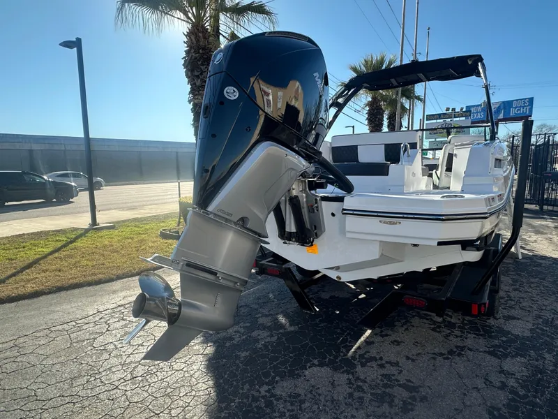 Slide: The Image of 2025 Monterey M-45 boat with powerful outboard motor, parked on a sunny day. - 5