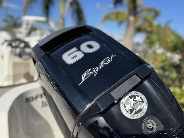 Slide: The Image of Close-up of a 2014 Bayliner 160 Bowrider's 60 HP Bigfoot outboard motor. - 11