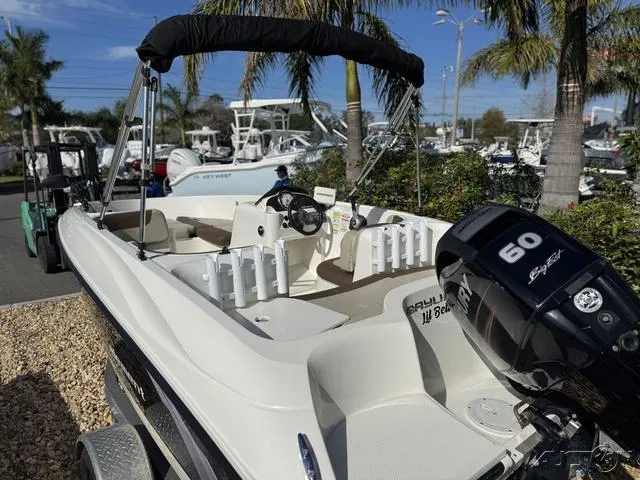 Slide: The Image of 2014 Bayliner 160 Bowrider boat with 60 HP engine, parked outdoors. - 12