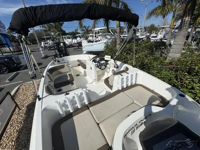 Slide: The Image of 2014 Bayliner 160 Bowrider with seating and canopy, parked in a marina. - 15
