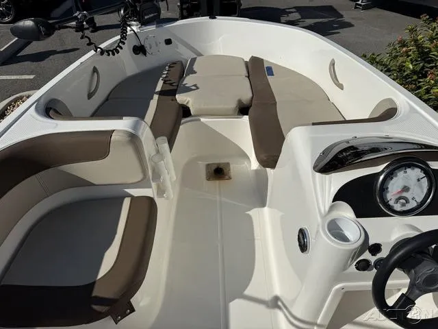 Slide: The Image of 2014 Bayliner 160 Bowrider interior with seating and dashboard view. - 19