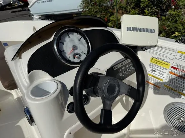 Slide: The Image of 2014 Bayliner 160 Bowrider dashboard with steering wheel and Humminbird fishfinder. - 20
