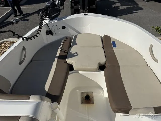 Slide: The Image of 2014 Bayliner 160 Bowrider interior with cushioned seating and steering controls. - 21