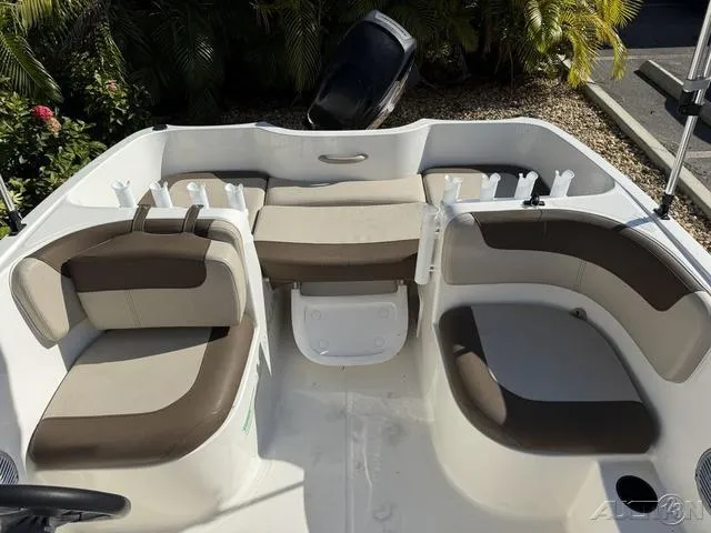 Slide: The Image of 2014 Bayliner 160 Bowrider interior with cushioned seating and rod holders. - 24