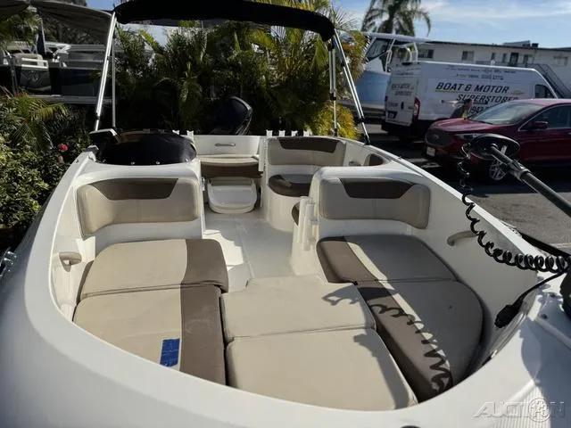 Slide: The Image of 2014 Bayliner 160 Bowrider boat interior with cushioned seating and steering console. - 5