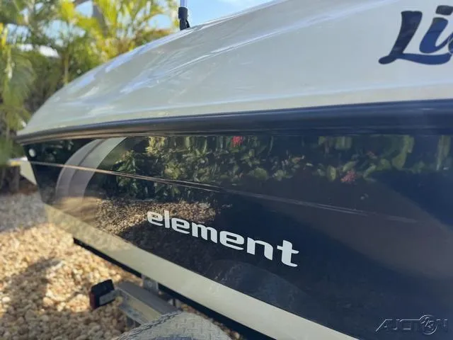 Slide: The Image of 2014 Bayliner 160 Bowrider boat side view with "Element" branding, parked on gravel. - 8