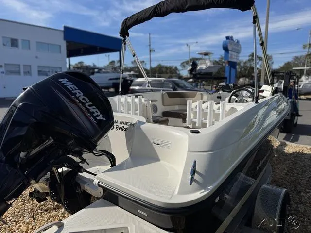 Slide: The Image of 2014 Bayliner 160 Bowrider with Mercury outboard motor, parked outdoors. - 9