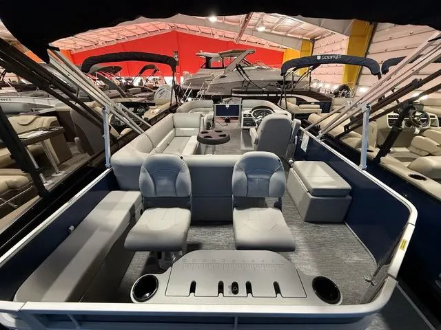 Slide: The Image of 2025 Godfrey Pontoons Xperience 2286 FSX interior with seating and helm in showroom. - 22
