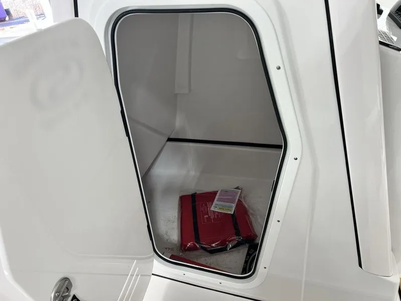 Slide: The Image of 2025 Sportsman Masters 247OE Bay Boat interior with cushioned seating and storage compartments. - 12