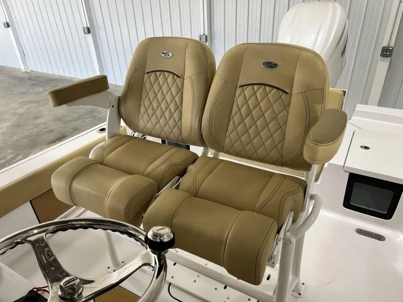 Slide: The Image of Open storage compartment on 2025 Sportsman Masters 247OE Bay Boat, featuring cushioned seating. - 14