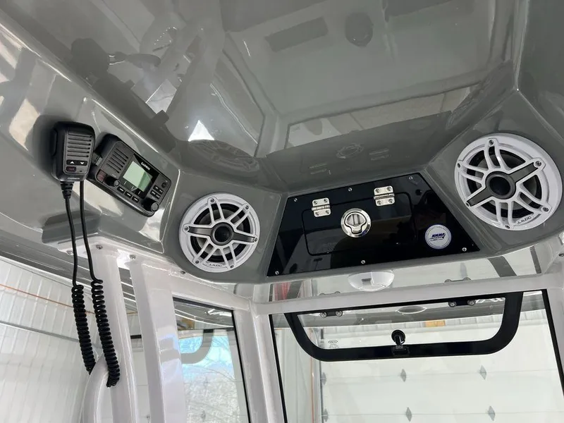 Slide: The Image of Storage compartment in 2025 Sportsman Masters 247OE Bay Boat, featuring secure latch and interior items. - 19