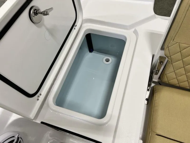 Slide: The Image of 2025 Sportsman Masters 247OE Bay Boat with tan cushioned seating and armrests. - 24