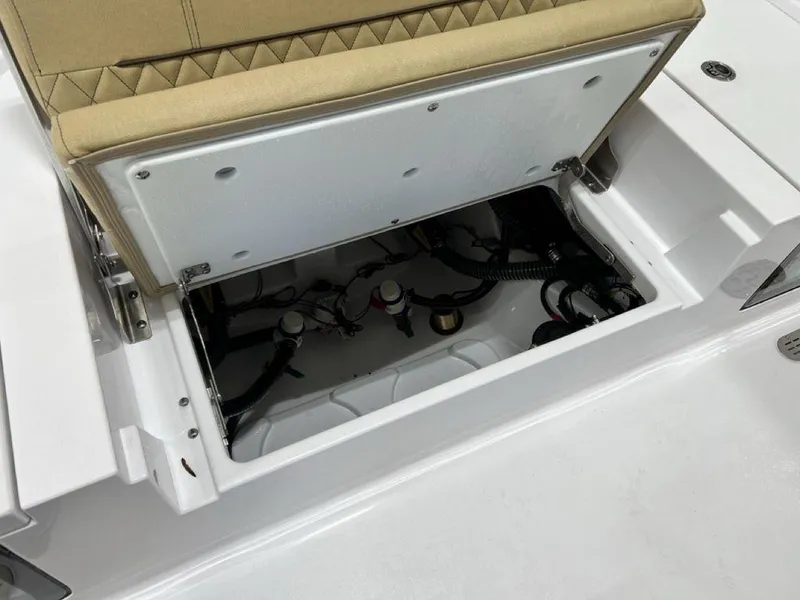 Slide: The Image of 2025 Sportsman Masters 247OE Bay Boat interior with tan seating and storage compartments. - 25