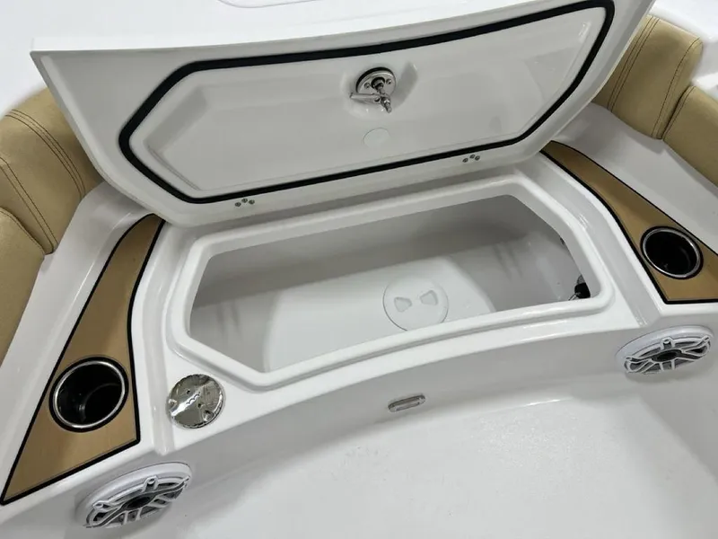 Slide: The Image of 2025 Sportsman Masters 247OE Bay Boat interior with tan seating and storage compartments. - 8