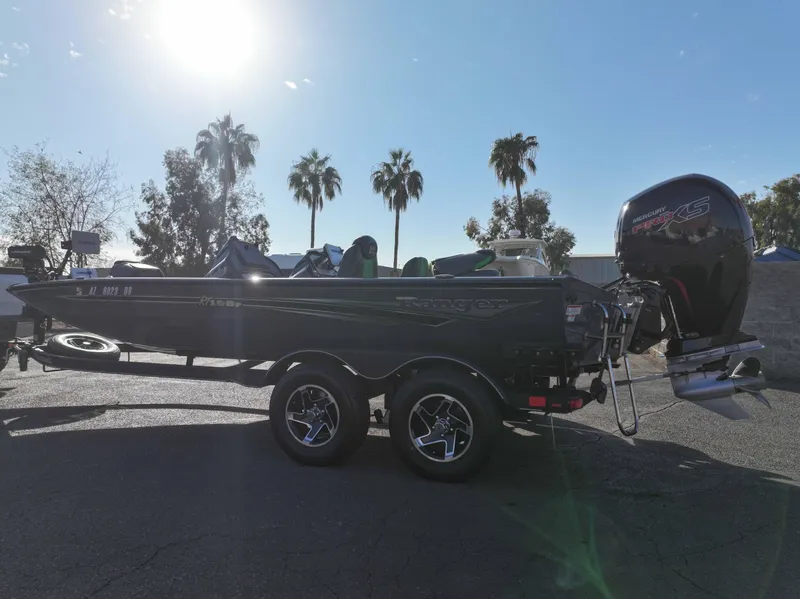 Slide: The Image of 2023 Ranger RT198P boat with outboard motor, parked under sunny sky. - 12