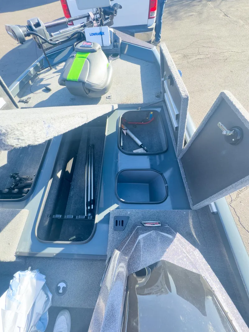 Slide: The Image of 2023 Ranger RT198P boat interior with storage compartments and fishing gear. - 14