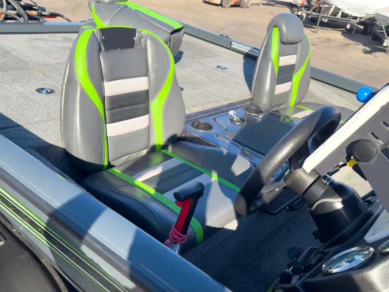 Slide: The Image of 2023 Ranger RT198P boat interior with green and gray seats, steering wheel, and console. - 16