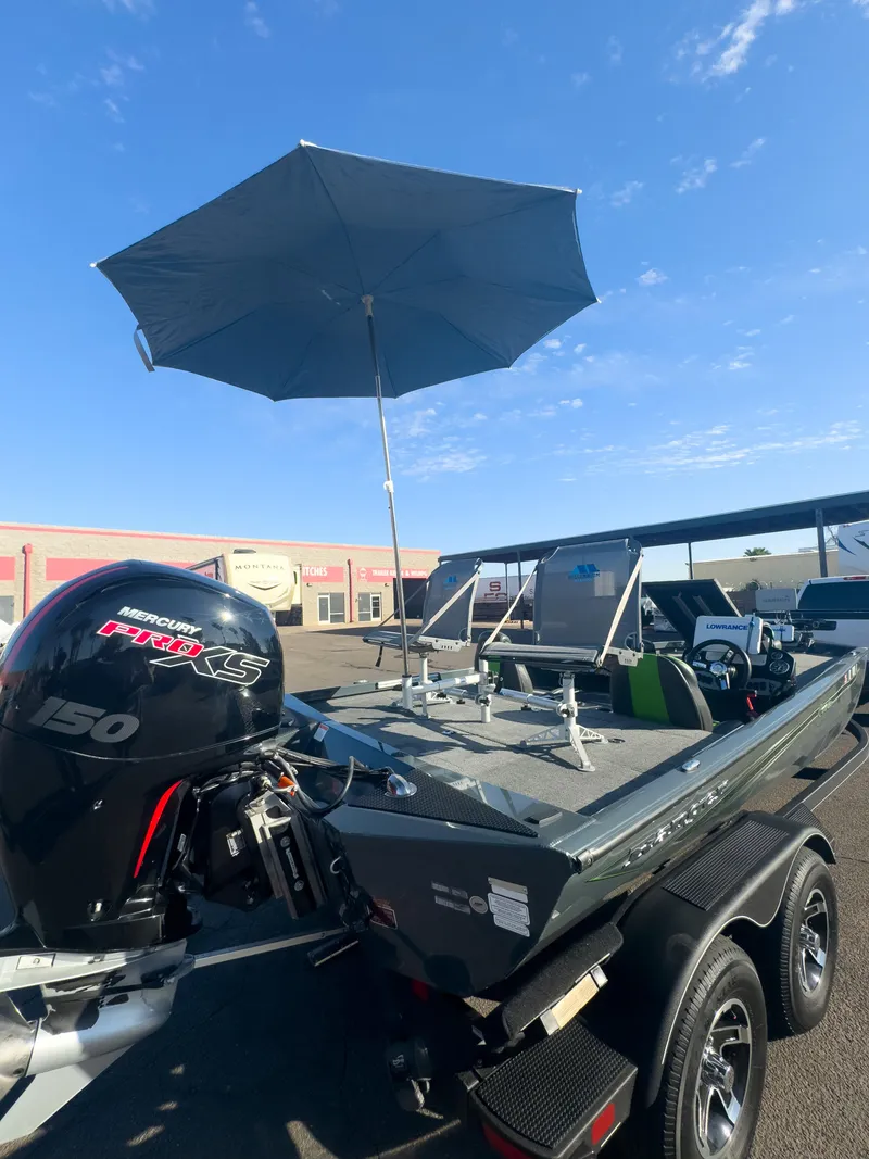 Slide: The Image of 2023 Ranger RT198P boat with umbrella and powerful 150 engine in sunny setting. - 19