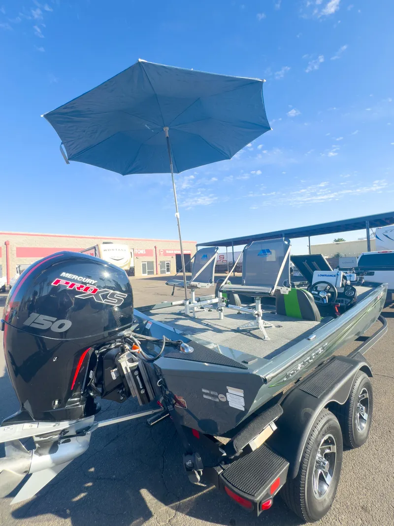 Slide: The Image of 2023 Ranger RT198P boat with umbrella, parked on trailer under clear blue sky. - 20