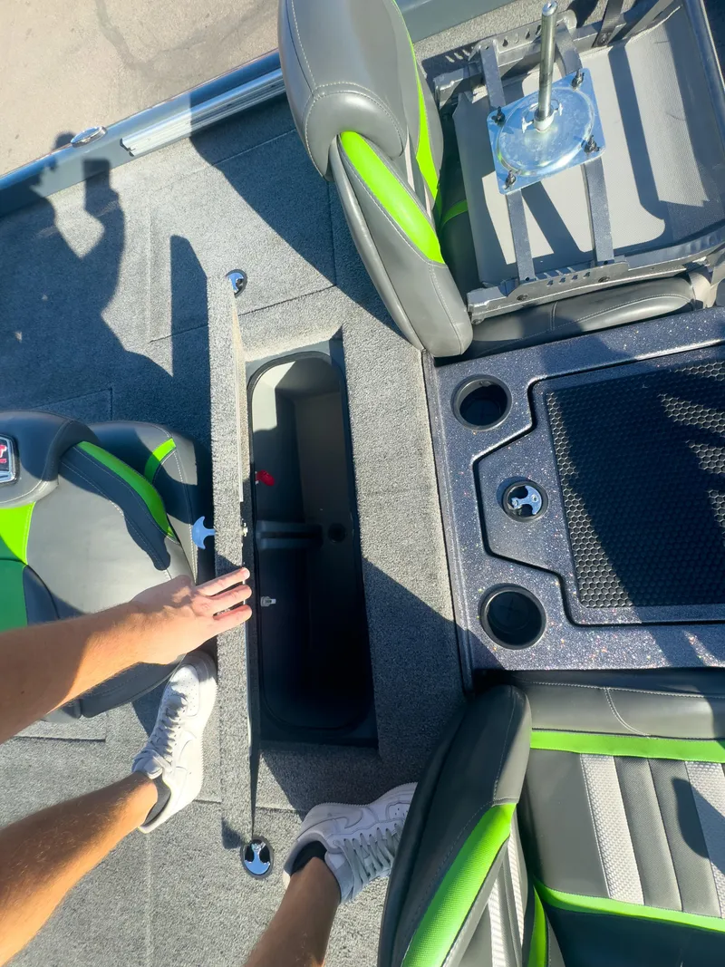 Slide: The Image of 2023 Ranger RT198P boat interior with green accents and storage compartment. - 3