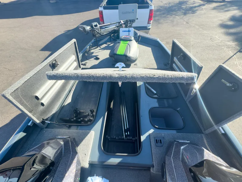 Slide: The Image of 2023 Ranger RT198P boat interior with open storage compartments and fishing gear. - 6