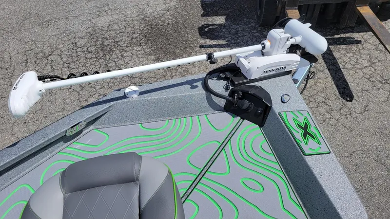 Slide: The Image of 2025 Xpress H24 Bay boat with Minn Kota trolling motor, featuring stylish green and gray design. - 11