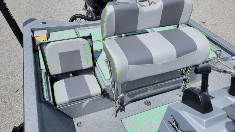 Slide: The Image of 2025 Xpress H24 Bay boat interior with gray and green seating, featuring Yamaha Vmax 250 SHO. - 16