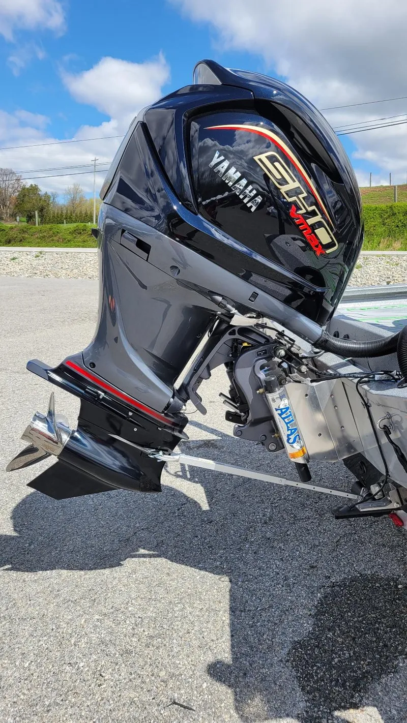 Slide: The Image of 2025 Xpress H24 Bay with Yamaha Vmax 250 SHO outboard motor, parked outdoors. - 18