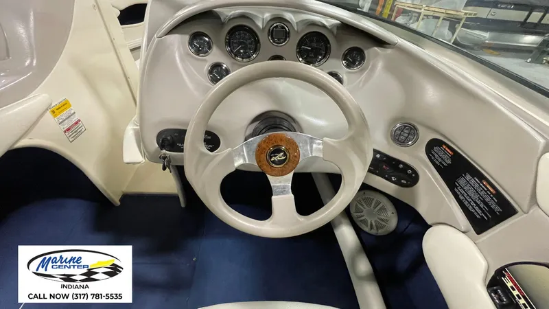 Slide: The Image of Interior dashboard of a 2000 Sea Ray 210 BR boat with steering wheel and gauges. - 10