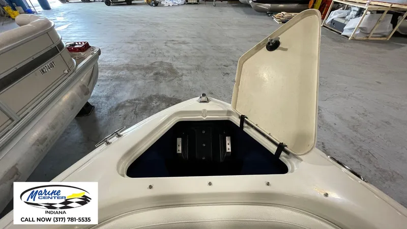 Slide: The Image of Open storage compartment on a 2000 Sea Ray 210 BR boat at Marine Center Indiana. - 14