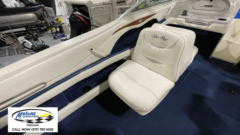 Slide: The Image of Interior of 2000 Sea Ray 210 BR boat with white seating and blue carpet. - 15
