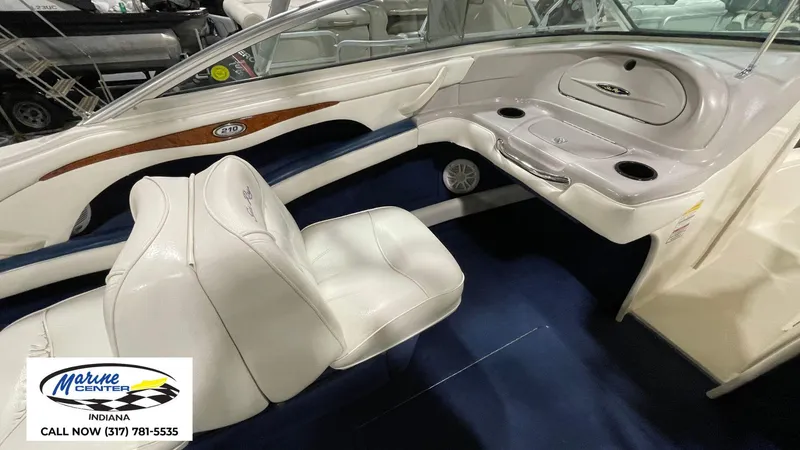 Slide: The Image of Interior of a 2000 Sea Ray 210 BR boat with white seating and dashboard. - 20