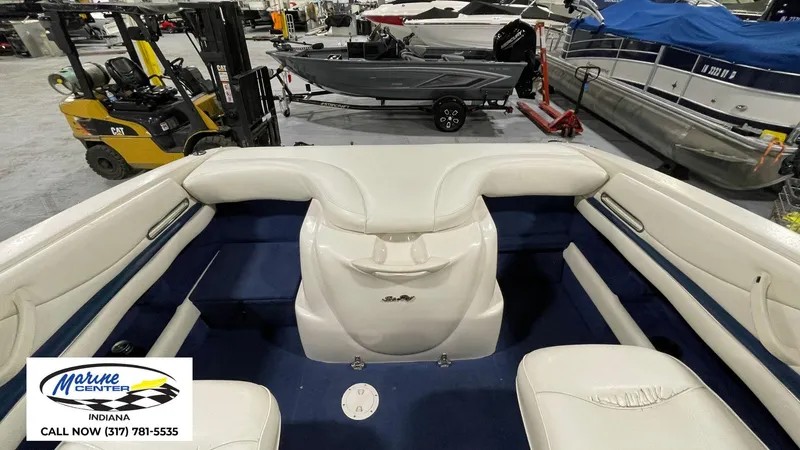 Slide: The Image of Interior of a 2000 Sea Ray 210 BR boat with white seating in a showroom. - 21