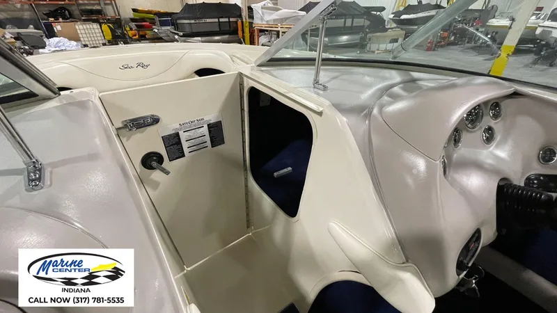 Slide: The Image of 2000 Sea Ray 210 BR boat interior with dashboard and storage compartment, Marine Center Indiana. - 7