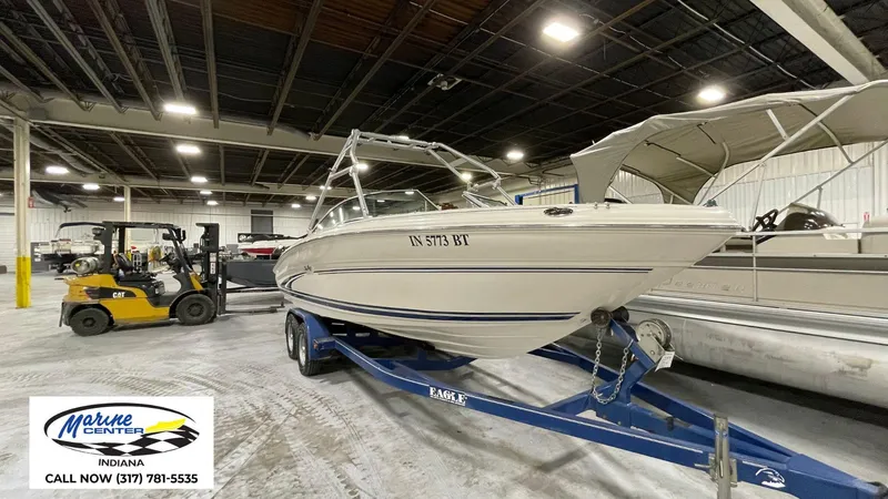 Slide: The Image of 2000 Sea Ray 210 BR boat on trailer in indoor storage facility. - 8