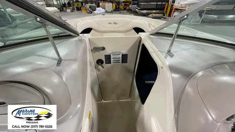 Slide: The Image of 2000 Sea Ray 210 BR boat interior with open storage compartment, displayed at Marine Center Indiana. - 9